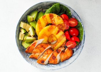 Bowl of Sliced Fruits, Checken, and Chopped Avocado
