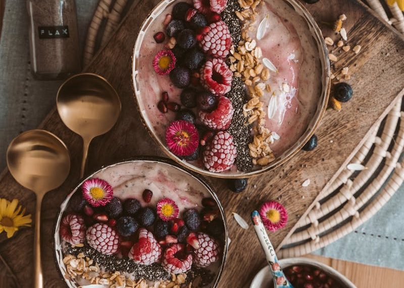 Red and White Round Fruits on Brown Wooden Bowl