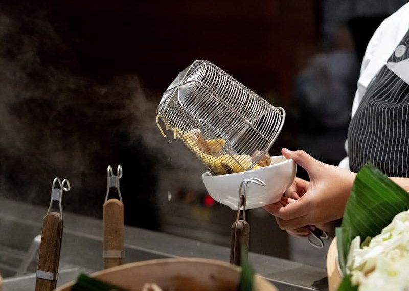 Woman Cooking at Stall with Food