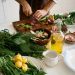 Person Slicing Vegetables on Chopping Board