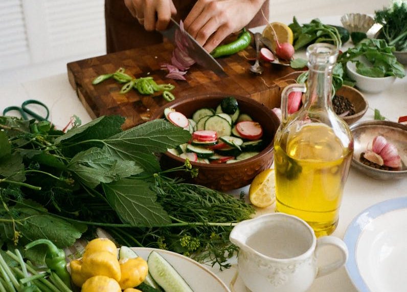Person Slicing Vegetables on Chopping Board