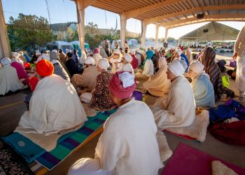 people sitting on floor while praying photo