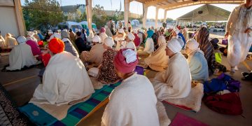 people sitting on floor while praying photo